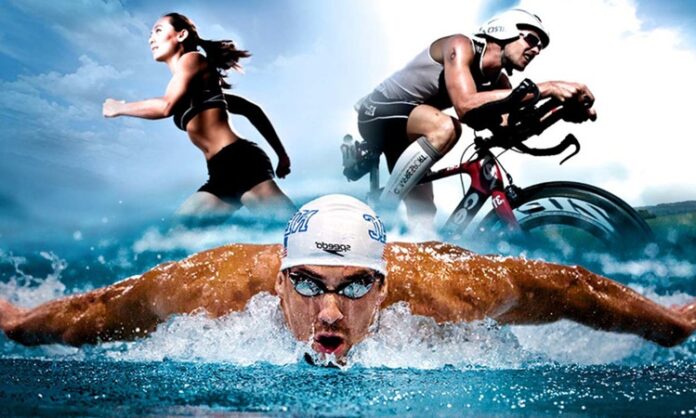 Triatlon Nedir ve Nasıl Yapılır Triatlon, üç farklı spor dalını ard arda yapan zorlu bir dayanıklılık sporu olarak bilinir. Bu spor dalı, yüzme, bisiklet sürme ve koşu olmak üzere üç aşamadan oluşur. Triatlon, olimpiyat sporları arasında yer almasının yanı sıra, dünya çapında pek çok amatör ve profesyonel sporcu tarafından büyük bir tutku ile yapılmaktadır. Triatlonun zorluk seviyesi oldukça yüksektir ve her bir aşama sporcuların fiziksel, zihinsel ve teknik becerilerini sınar. Konulu bir haber görseli.
